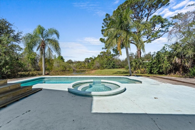 view of pool featuring a pool with connected hot tub and a patio area