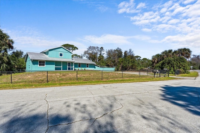 view of front of home with a fenced front yard and a front yard