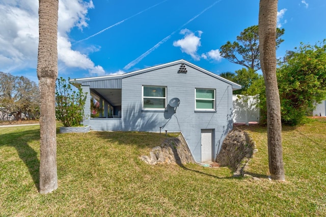 view of side of home with a lawn