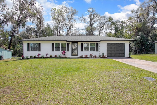 ranch-style home featuring a garage, a front yard, and driveway