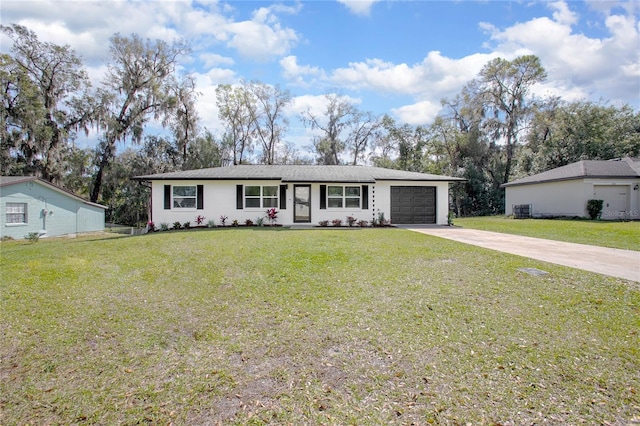 ranch-style home with a garage, cooling unit, driveway, and a front lawn