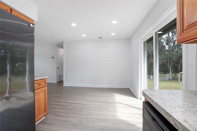 interior space featuring light wood finished floors, baseboards, visible vents, and recessed lighting