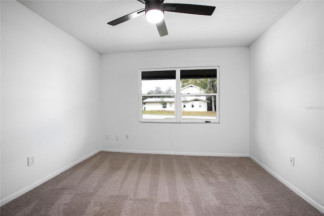 spare room featuring carpet floors, a ceiling fan, baseboards, and a textured ceiling