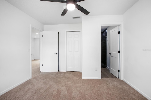 unfurnished bedroom featuring carpet, visible vents, ceiling fan, and baseboards