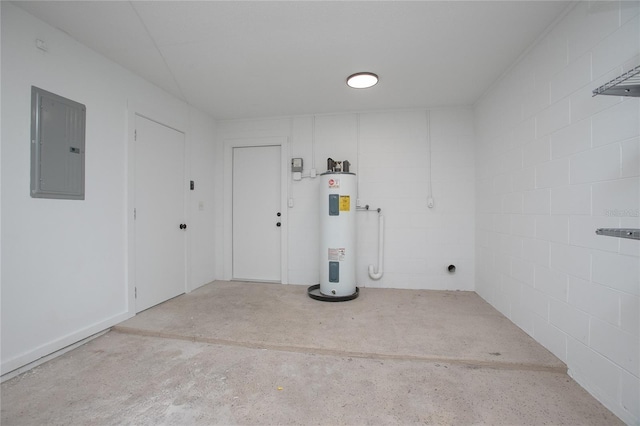 garage featuring water heater, electric panel, and concrete block wall