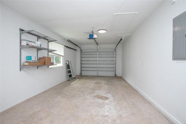 garage featuring baseboards, concrete block wall, electric panel, and a garage door opener