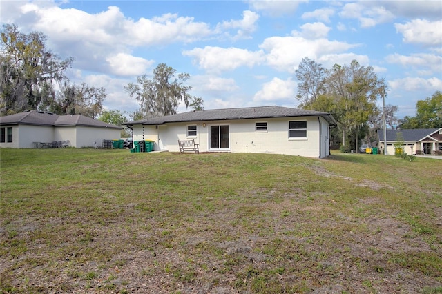 back of property featuring a yard