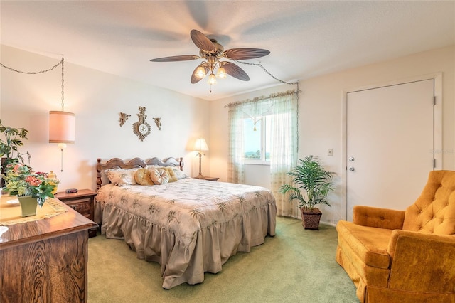 bedroom with a ceiling fan and light colored carpet