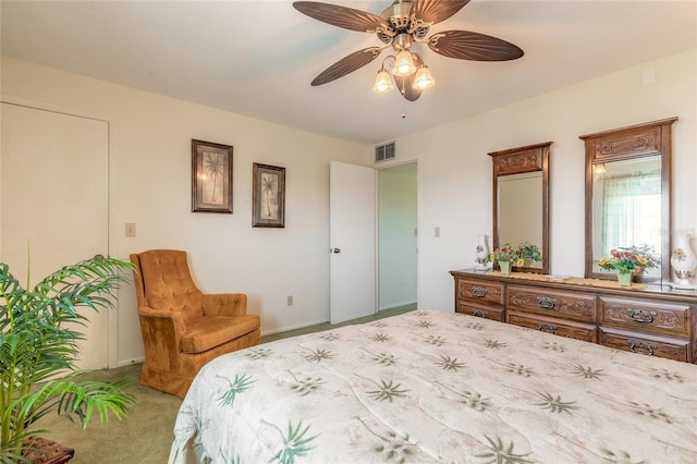 carpeted bedroom with a ceiling fan and visible vents