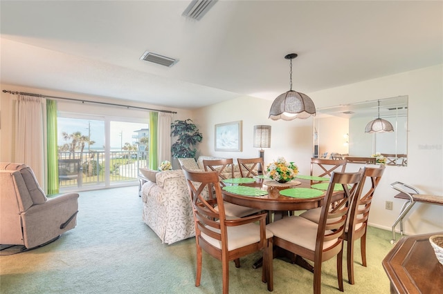 carpeted dining area featuring baseboards and visible vents