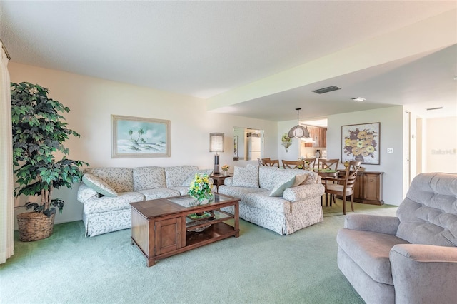 living area with light carpet and visible vents