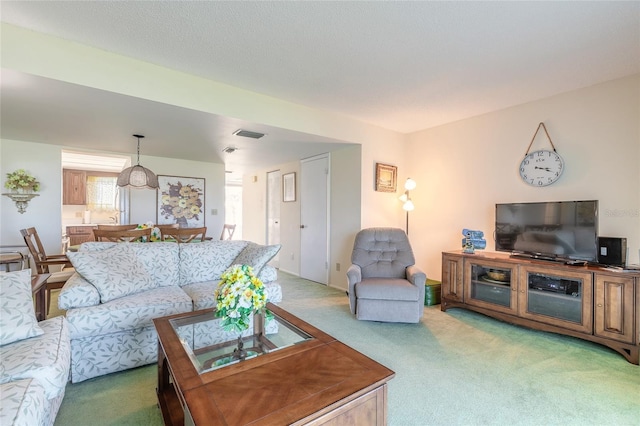 living area with light carpet and visible vents