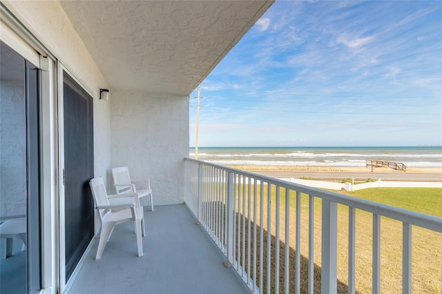 balcony with a view of the beach and a water view