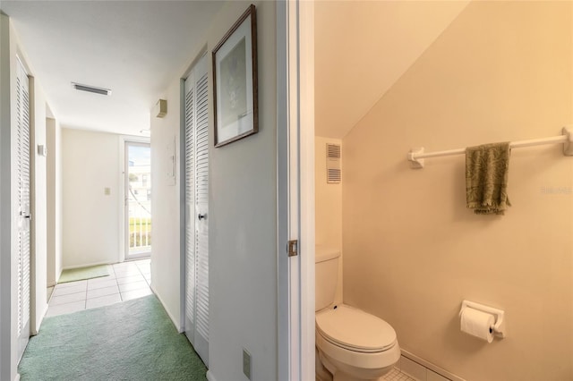 bathroom featuring visible vents, tile patterned flooring, and toilet