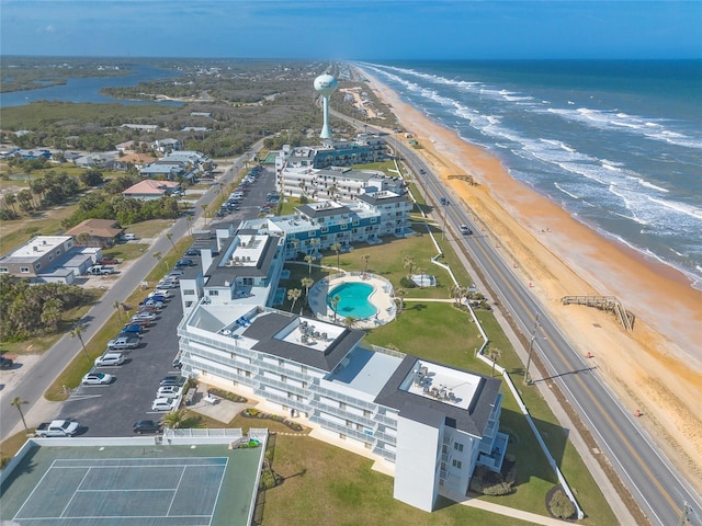 birds eye view of property with a water view and a view of the beach