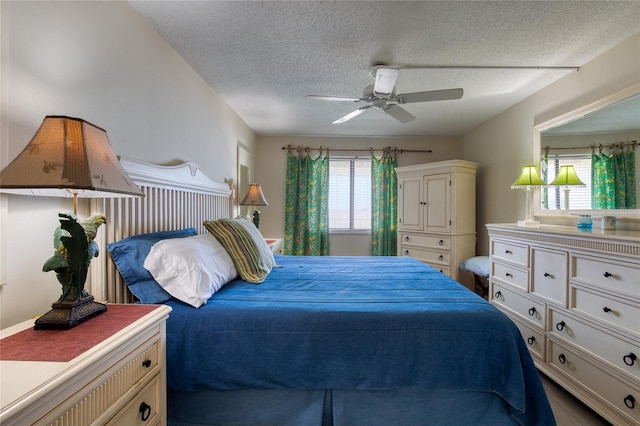 bedroom featuring a textured ceiling, multiple windows, and a ceiling fan