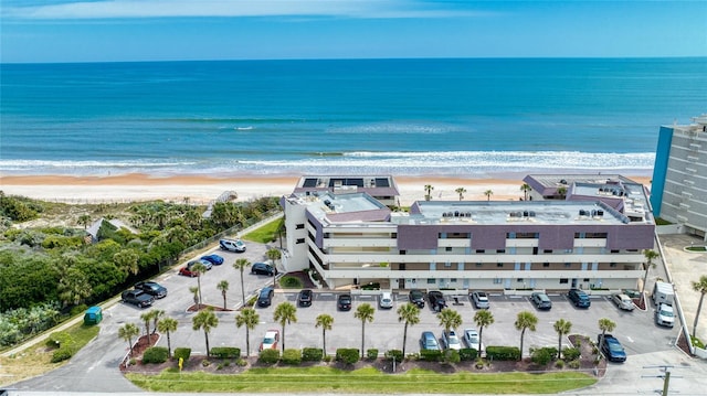 bird's eye view featuring a water view and a beach view