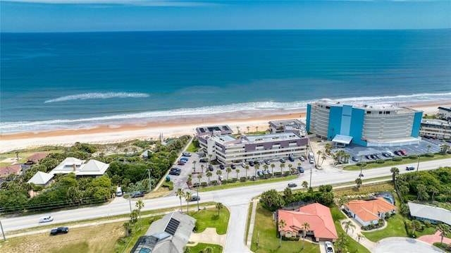 drone / aerial view with a water view and a beach view