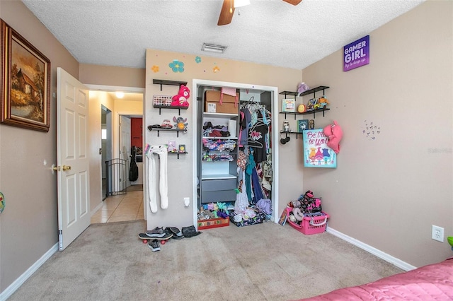 carpeted bedroom featuring a closet, baseboards, and a textured ceiling