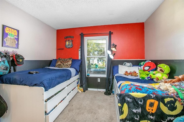 bedroom with carpet and a textured ceiling