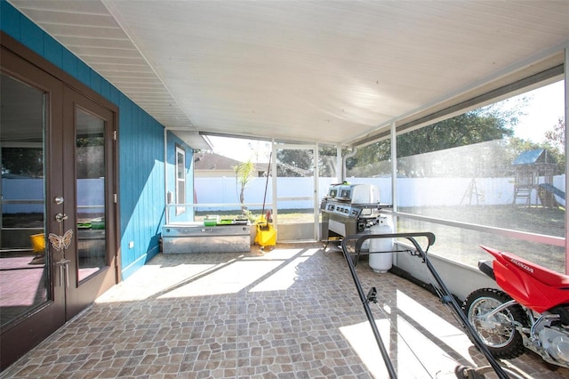 sunroom / solarium featuring french doors