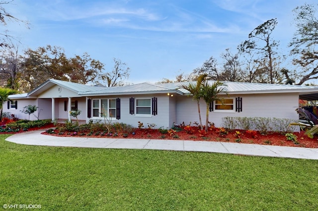 single story home with a front yard and metal roof