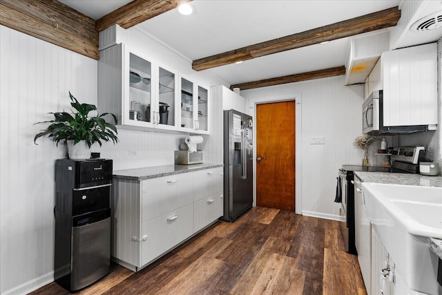 kitchen with stainless steel appliances, visible vents, beam ceiling, dark wood finished floors, and glass insert cabinets