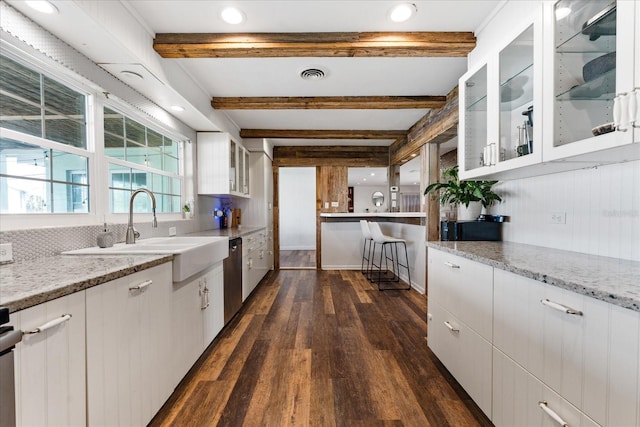 kitchen with visible vents, a sink, and white cabinetry