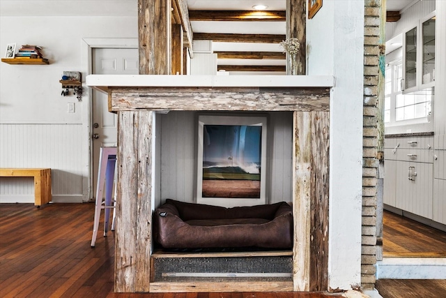 interior details with a wainscoted wall and wood finished floors