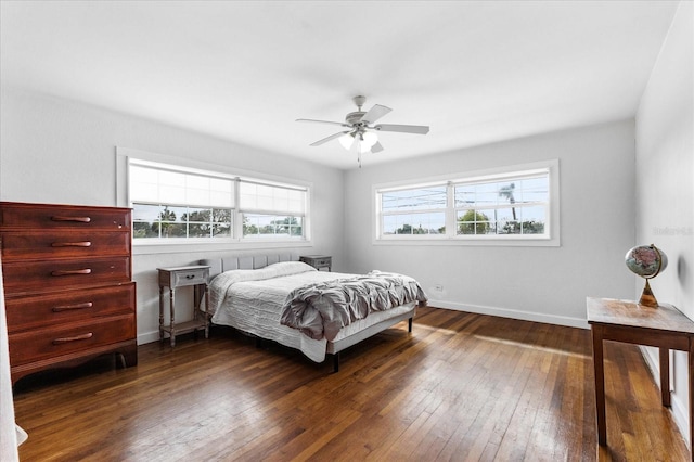 bedroom with ceiling fan, baseboards, and dark wood finished floors