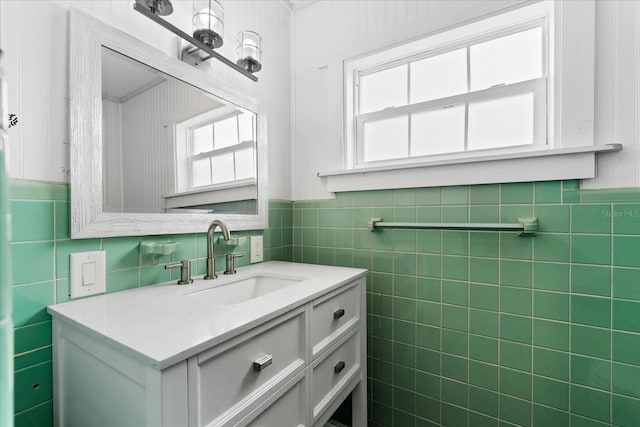 bathroom featuring a wainscoted wall, tile walls, and vanity