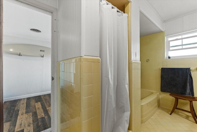 bathroom with curtained shower and visible vents