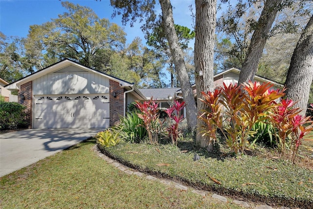 view of front of property featuring driveway, brick siding, and an attached garage