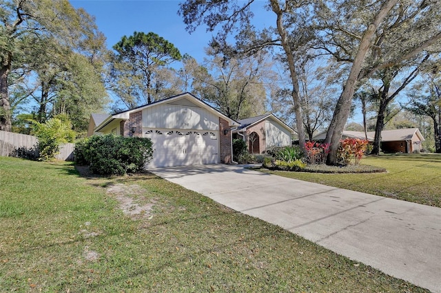 view of front of home featuring an attached garage, brick siding, fence, concrete driveway, and a front yard