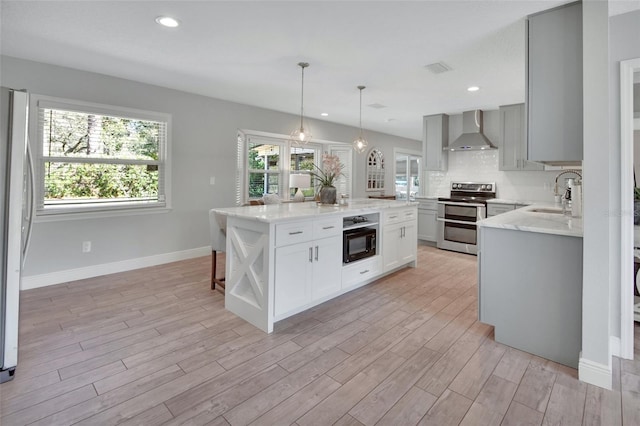 kitchen featuring black microwave, range with two ovens, open shelves, a sink, and wall chimney exhaust hood