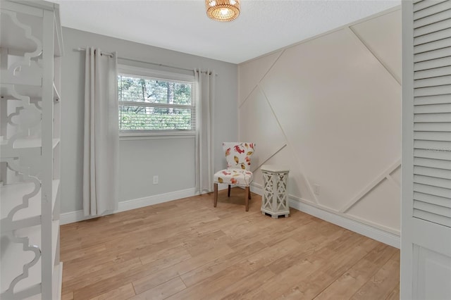 living area with baseboards and light wood-style floors