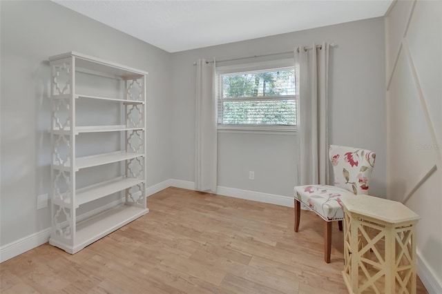 sitting room featuring baseboards and wood finished floors