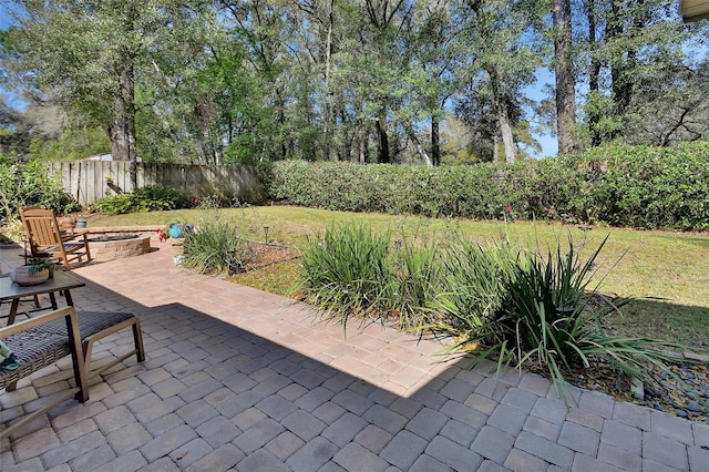 view of patio / terrace featuring an outdoor fire pit and fence