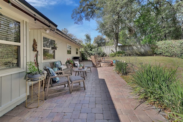 view of patio / terrace featuring an outdoor fire pit and fence