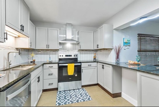 kitchen featuring stainless steel appliances, backsplash, a sink, dark stone countertops, and wall chimney exhaust hood