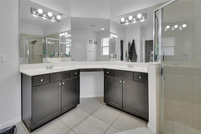 full bathroom featuring a stall shower, tile patterned floors, a sink, and double vanity