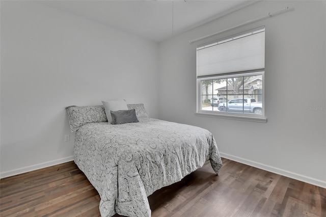 bedroom featuring baseboards and wood finished floors