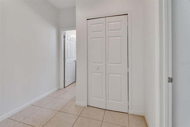 interior space featuring light tile patterned floors and baseboards