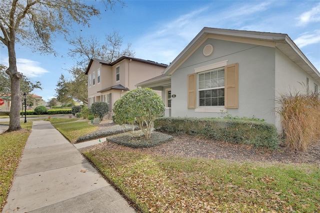 view of side of home with stucco siding