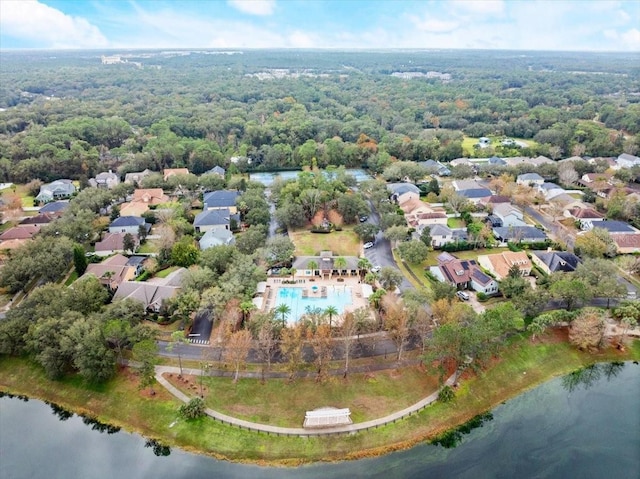 bird's eye view with a water view, a residential view, and a wooded view