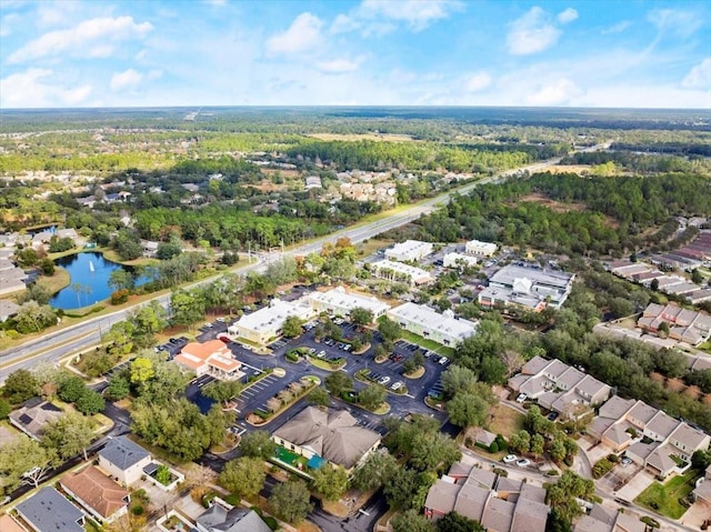 aerial view with a residential view, a water view, and a view of trees