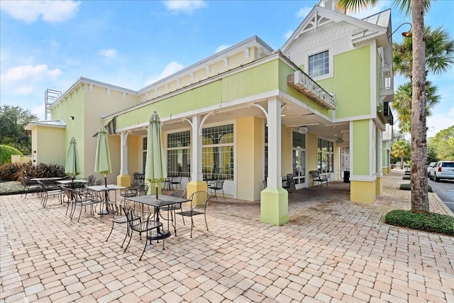 rear view of property featuring a patio and stucco siding