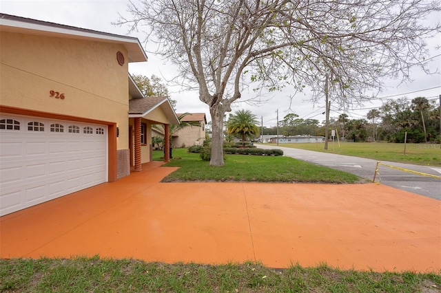 view of yard with an attached garage and a water view