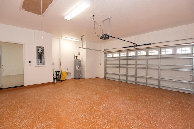 garage with baseboards, a garage door opener, and electric water heater