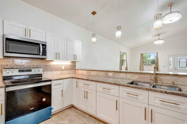 kitchen featuring white cabinets, decorative backsplash, vaulted ceiling, stainless steel appliances, and a sink